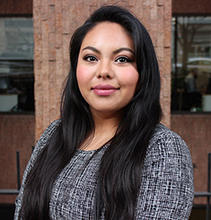 Women with long dark hair smiling