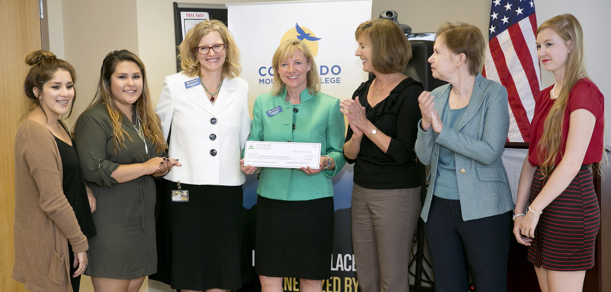 Group celebrating matching student scholarship